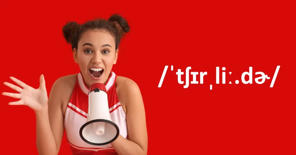 Cheerleader rouge avec mégaphone à côté du mot /ˈtʃɪrˌliː.dɚ/ (cheerleader en phonétique)